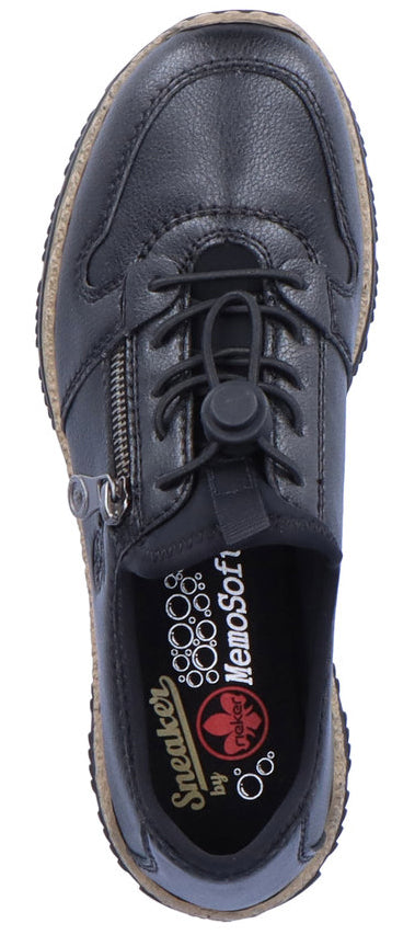 A black slip-on sneaker with laces and a side zipper. The insole has the text "Sneaker by rieker MemoSoft".