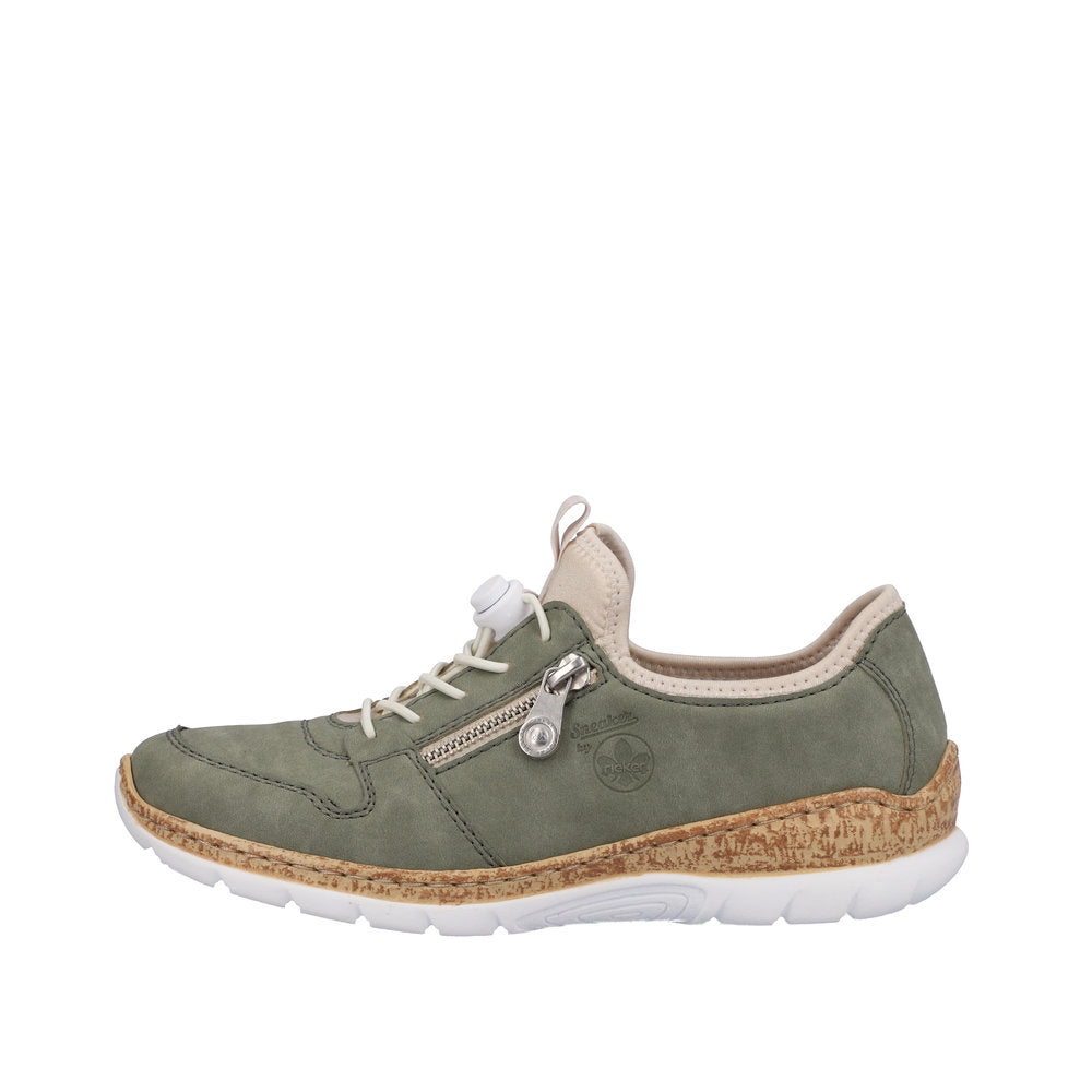 A green sneaker with a beige collar, a side zipper, a cork-like midsole, and a white outsole.