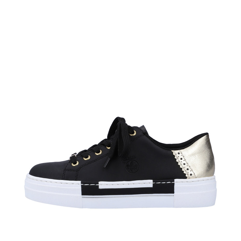 A black, lace-up sneaker with gold accents, and a white sole.