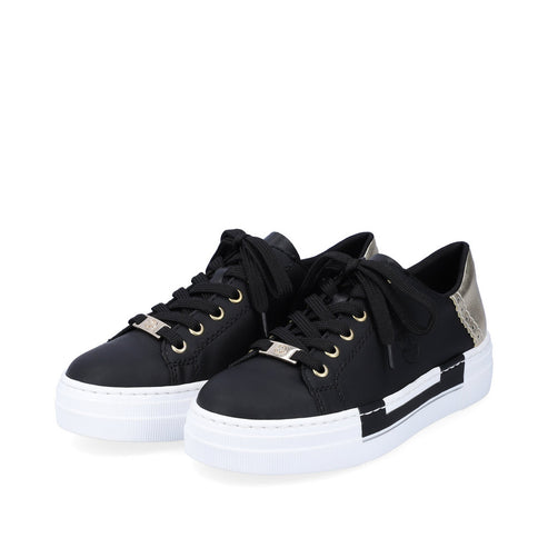 A pair of black low top sneakers with white platform soles and black laces.