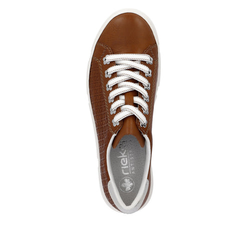 Tan sneaker with white laces and sole, visible logo on insole.
