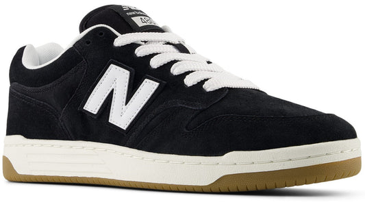 A black suede sneaker with a white N logo on the side, white laces, a white midsole, and a tan gum rubber outsole, featuring the text 480 on the tongue tag.