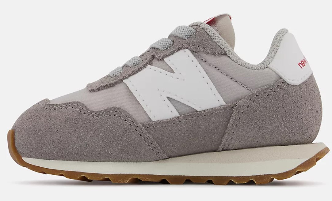 Gray sneaker with a white 'N' logo and brown sole.
