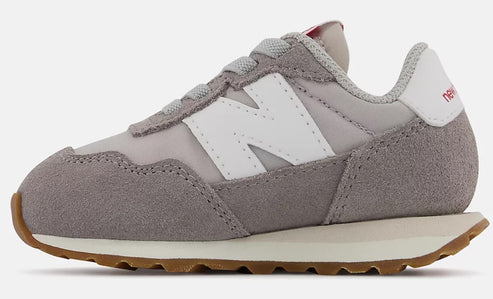 Gray sneaker with a white 'N' logo and brown sole.