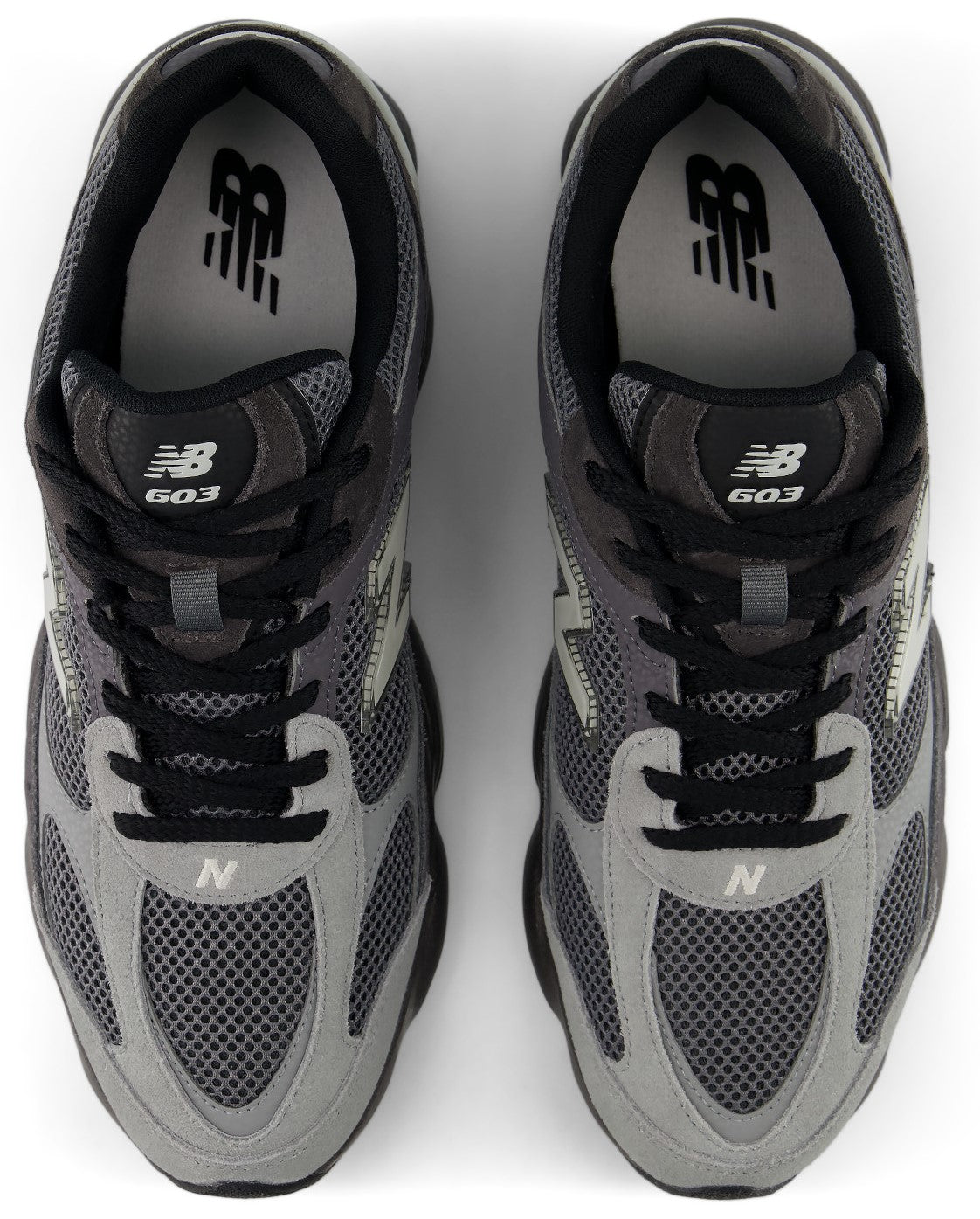 A pair of grey and black New Balance 603 sneakers viewed from above, featuring mesh uppers, black laces, and the New Balance logo on the tongue and insole.