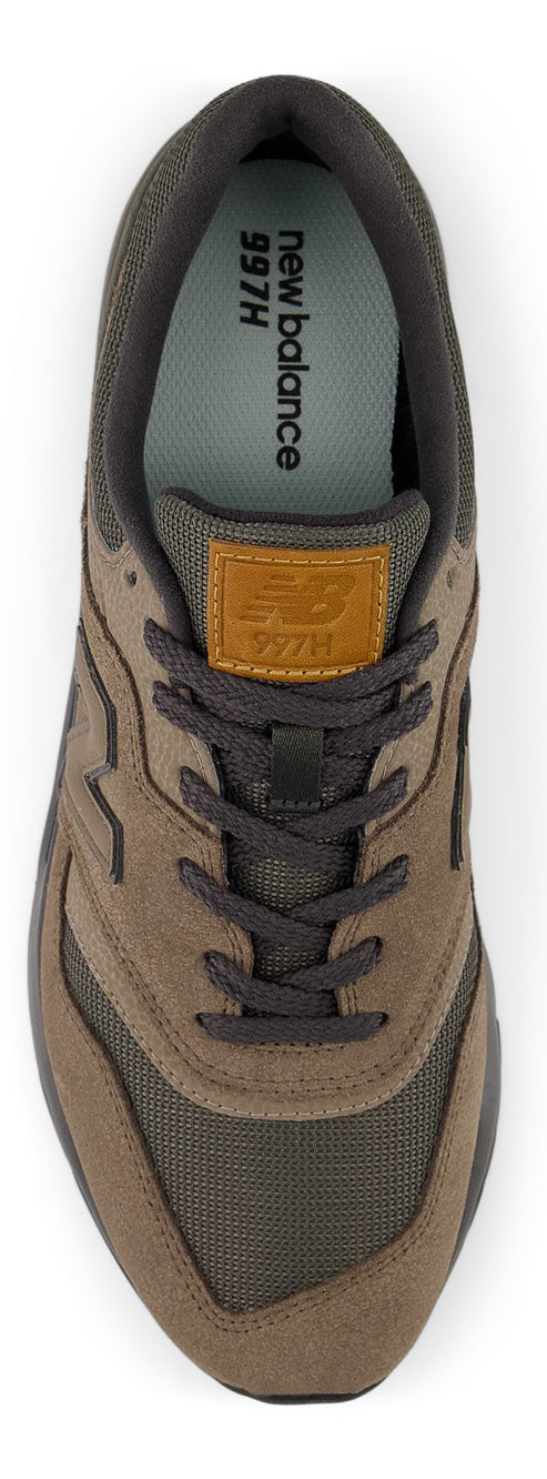 A top-down view of a sneaker with brown laces and a leather tag with the text '997H'.