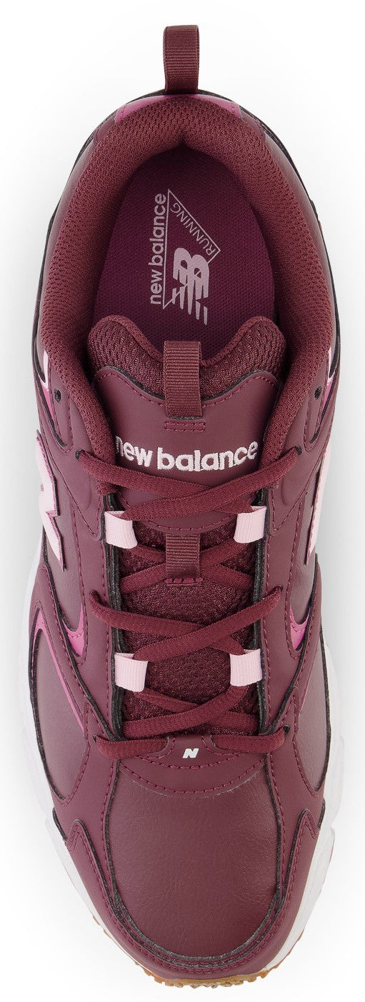 A top-down view of a burgundy-colored athletic sneaker with a lace-up front, light pink lace loops, and white branding text on the tongue and inside the heel.