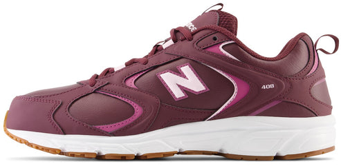 A maroon New Balance 408 athletic shoe with a white midsole and brown rubber outsole, showing a side view with pink and maroon accents and a white 'N' logo.