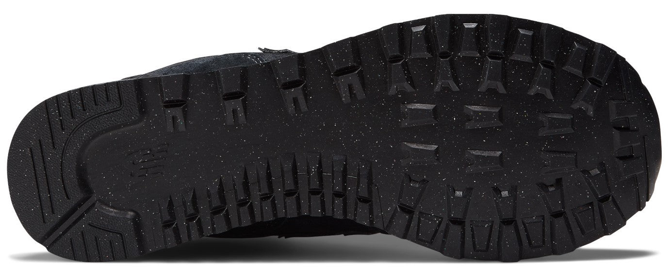 A view of the black rubber outsole of a sneaker, featuring a lugged tread pattern for traction and speckled detailing.