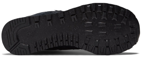 A view of the black rubber outsole of a sneaker, featuring a lugged tread pattern for traction and speckled detailing.