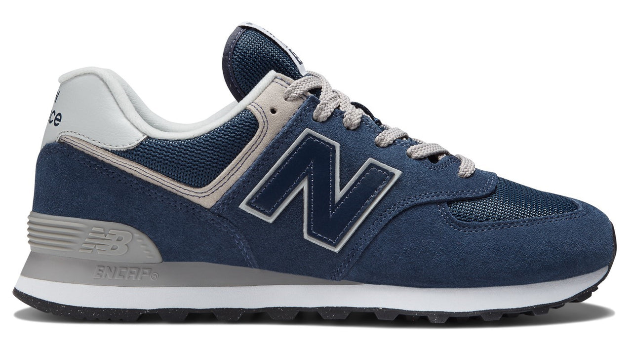 A blue suede shoe with gray laces and a white "N" logo.