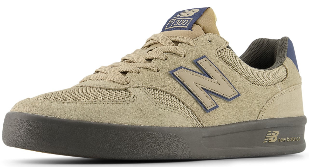 Low top sneaker featuring tan suede and mesh upper, blue "N" logo and heel accent, "300" logo on tongue, and dark gray rubber sole.