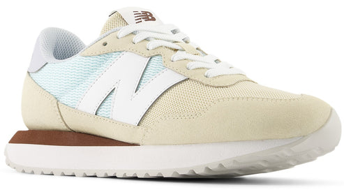 Tan and white sneaker with a large white N on the side, a brown accent at the heel, and a white sole.