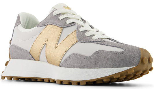 A white and gray athletic shoe with a gold 'N' on the side and a brown lug sole.