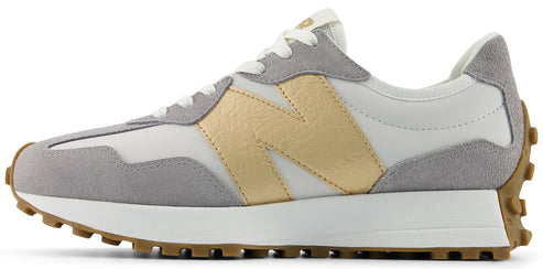 A New Balance 327 sneaker featuring a grey suede and white nylon upper with a gold leather "N" logo on the side.