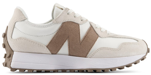 A low-top sneaker with an off-white leather upper, light beige suede overlays at the toe and heel, and a prominent tan suede N logo on the side, set against a thick white midsole and a textured brown rubber outsole that extends up the heel.