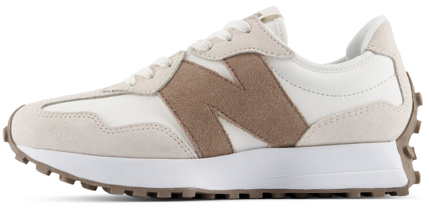 A low-top athletic sneaker featuring a cream-colored mesh and suede upper, a large textured tan logo on the side, a white foam midsole, and a brown lugged rubber outsole extending up the heel.