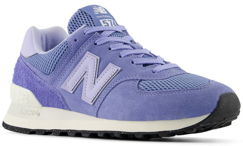 A purple New Balance 574 sneaker with a mesh and suede upper, white midsole, and black outsole.