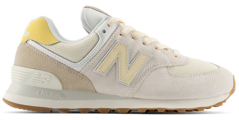 A low-top athletic sneaker in shades of off-white, beige, and pale yellow with a brown rubber outsole, mesh and suede paneling, and an N logo on the side.
