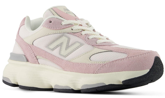 A low-top athletic shoe with white mesh and soft pink suede panels featuring a prominent N logo on the side, white laces, an off-white midsole, and a black rubber outsole.