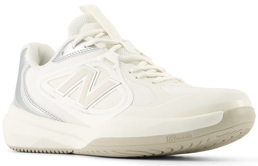 A low-top athletic sneaker featuring a cream-white upper with a large white N logo on the side, white laces, silver accents on the heel and collar, and a light tan rubber outsole with textured tread.