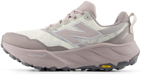 A light beige and mauve trail running shoe with a thick Fresh Foam X midsole, Vibram outsole, and the text "hierto" printed on the heel.