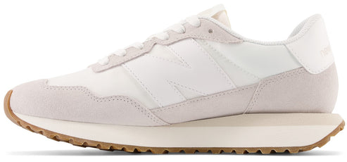A white sneaker with a brown sole.