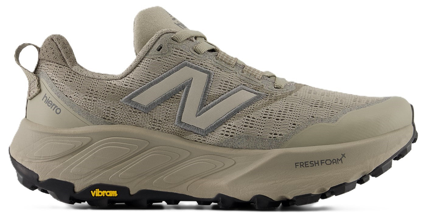Tan athletic shoe with an "N" logo, Fresh Foam X printed on the outsole, and a Vibram logo on the sole.