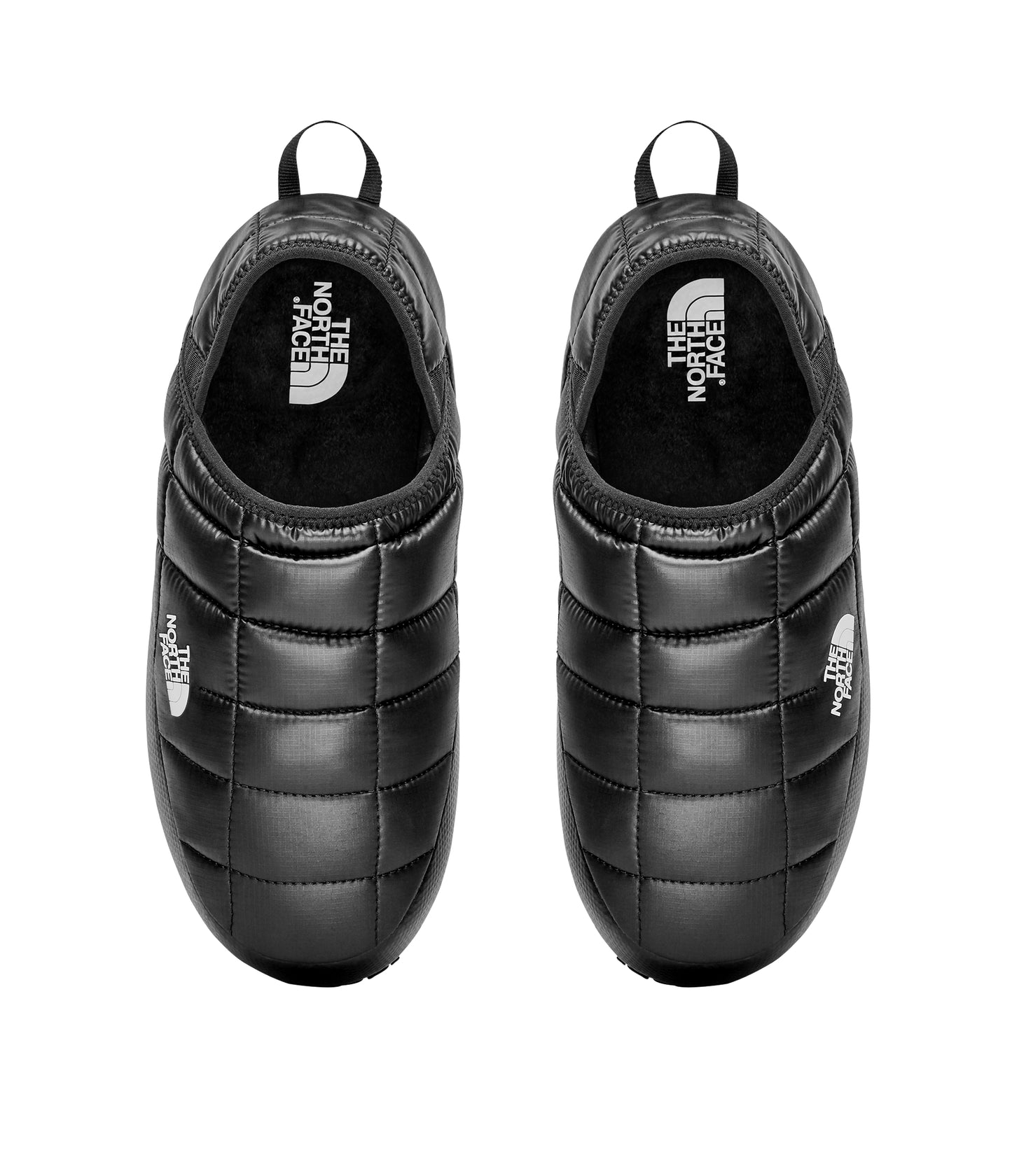 A pair of black quilted slippers with white logos, viewed from above.