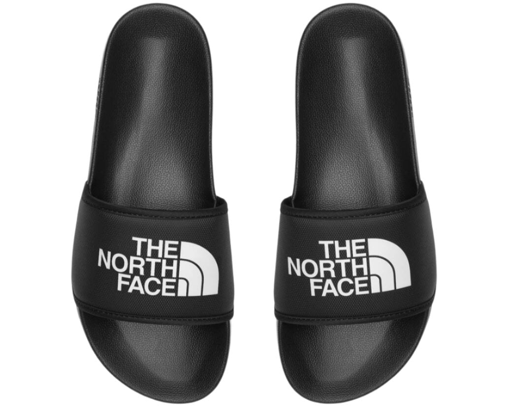 Pair of black sandals with white text "THE NORTH FACE" on the front.
