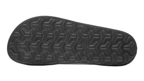 Black sandal bottom with triangular pattern.
