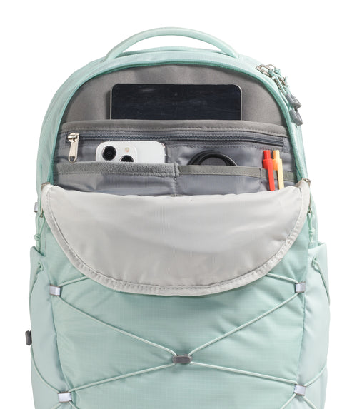 Light blue backpack with an open top, revealing internal pockets containing a phone, tablet, and pen.