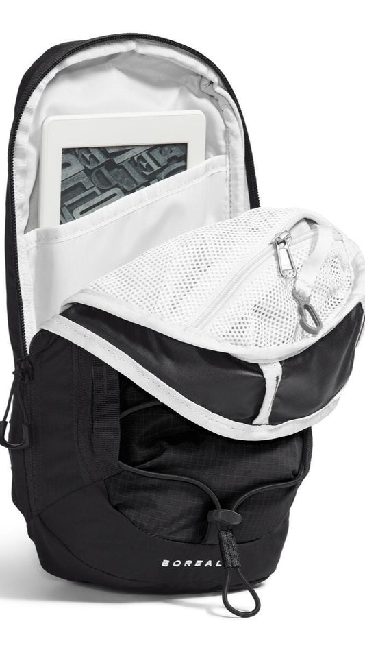 Open black backpack with internal white pocket holding a tablet.