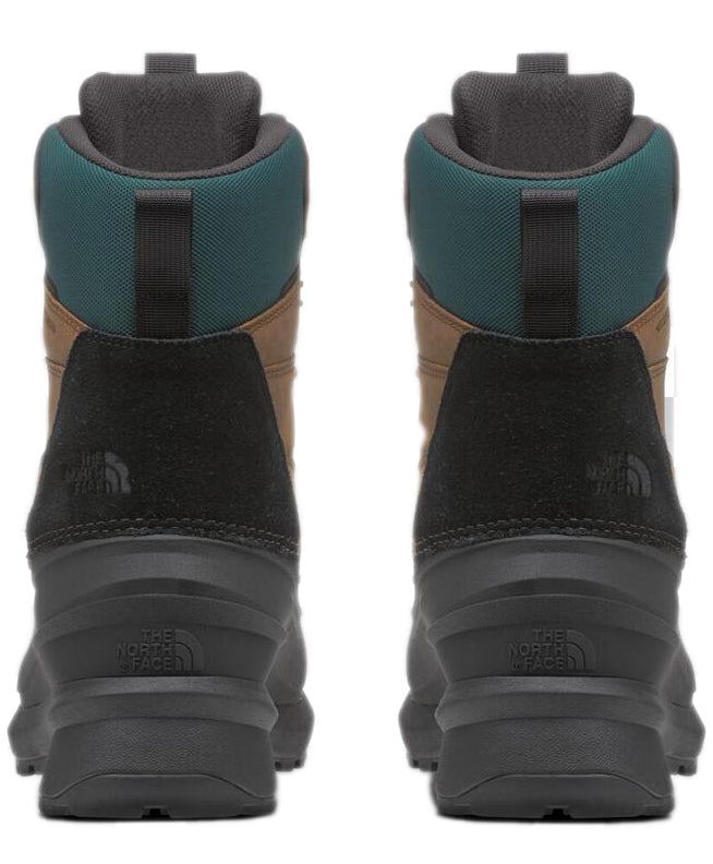Pair of black and tan hiking boots with a dark green collar, viewed from the back.