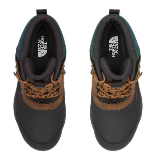 Overhead view of The North Face boots in black, brown, and green with printed laces. The label is visible inside.