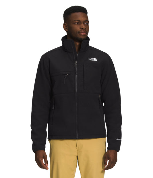 A man wearing a black zippered fleece jacket with white text on the upper right.