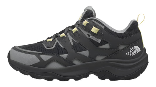 A black and gray hiking shoe with yellow accents and "THE NORTH FACE" printed on the side.
