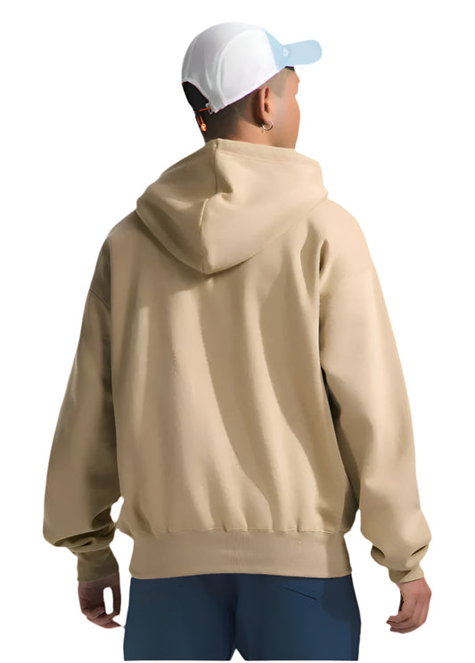 Person facing away wearing a beige hoodie and a baseball cap.