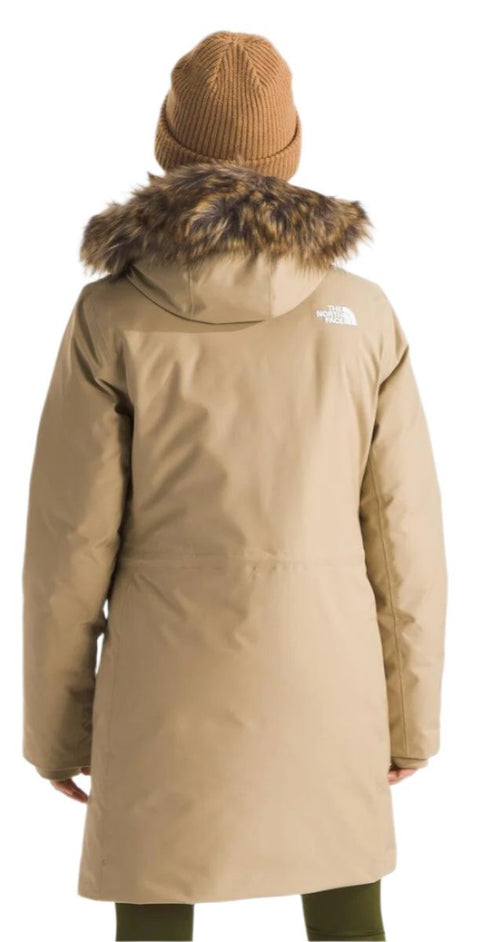 Back view of a tan parka with a fur-lined hood and a tan beanie.