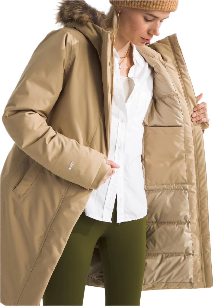 Tan parka with faux fur hood, open to reveal pockets and quilted lining.