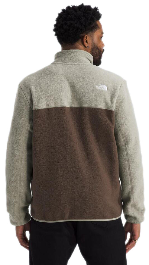 Back view of a man wearing a two-tone fleece jacket with a light gray upper and brown lower portion.