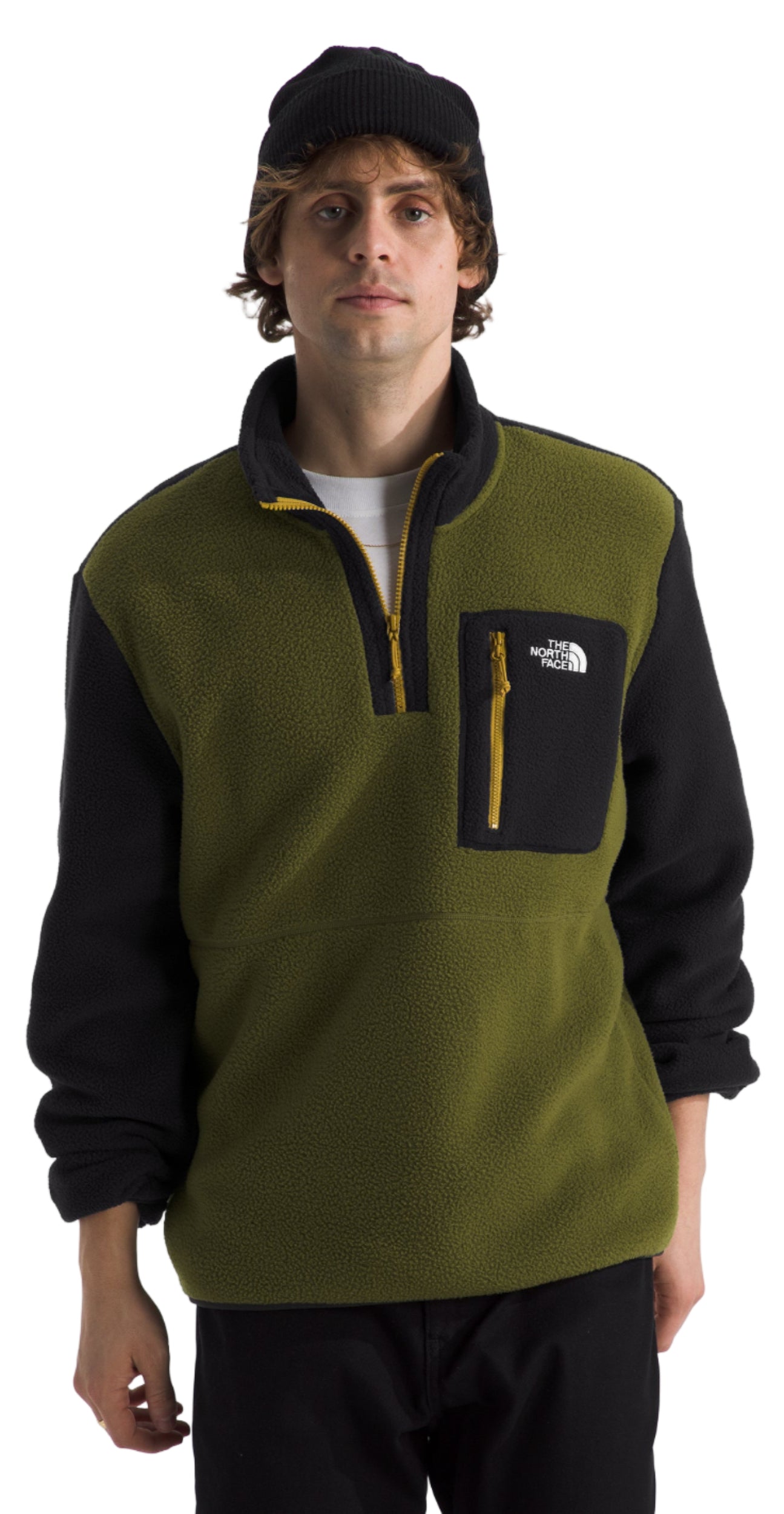 A person is wearing a green fleece pullover with black sleeves and a black beanie.