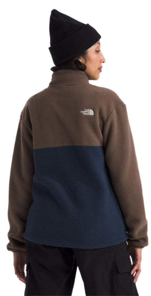 A person wearing a two-tone fleece with a brown top and a navy blue bottom.