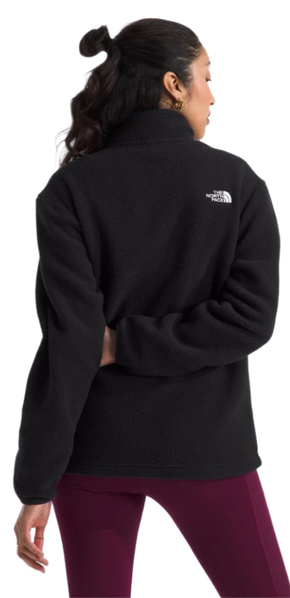 A person from the back wearing a black jacket and maroon pants.