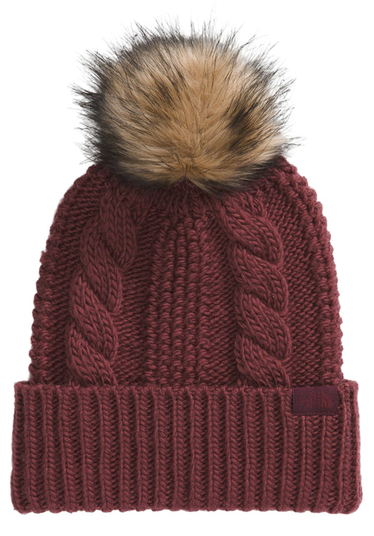 Maroon knit beanie with cable-knit design and faux-fur pompom.