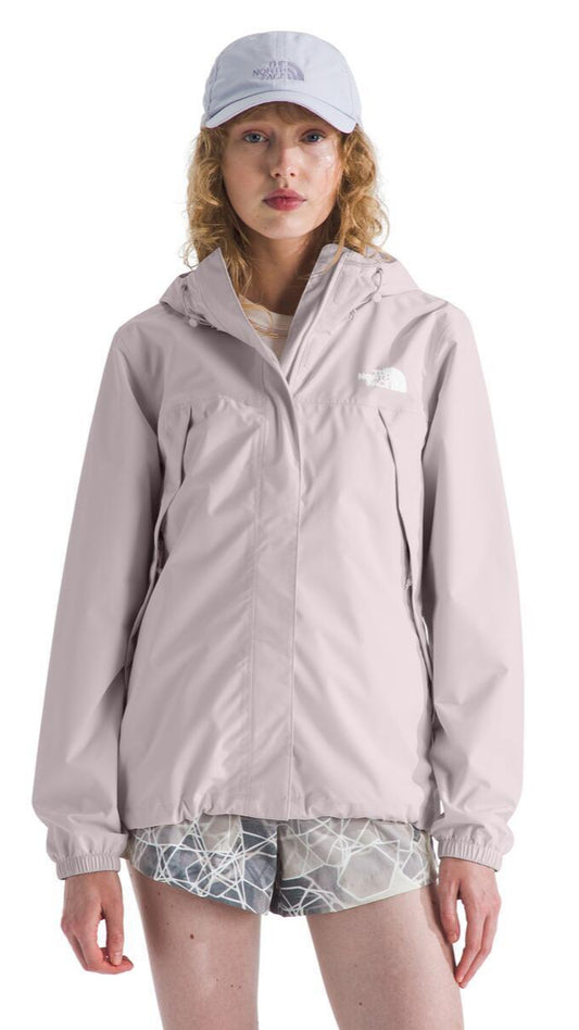 A person wearing a light purple rain jacket and matching baseball cap.