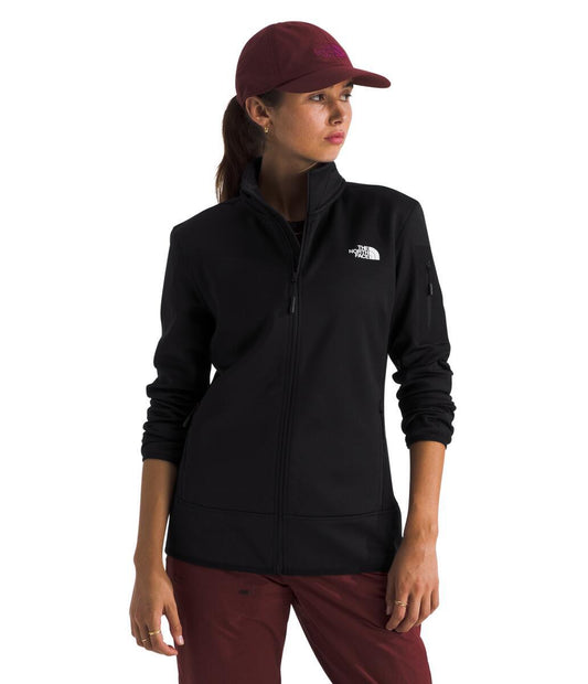 A woman wearing a black, long sleeve zipper jacket and a dark-red cap.