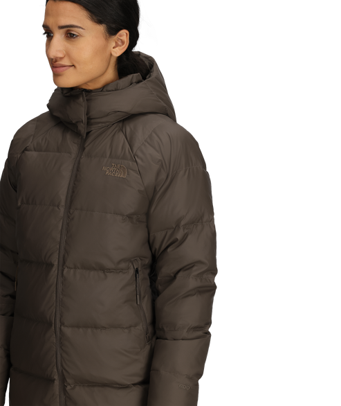 Woman wearing brown hooded puffer jacket.
