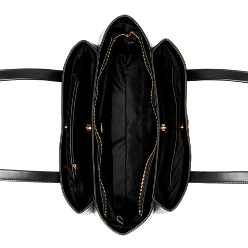 An overhead view of a black and white satchel bag with three zipper compartments.