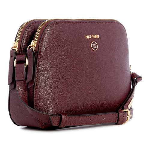 Burgundy crossbody bag with gold zippers and a visible "NINE WEST" logo.